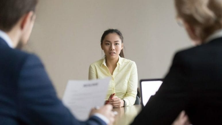 job candidate sitting across the table from two hiring managers