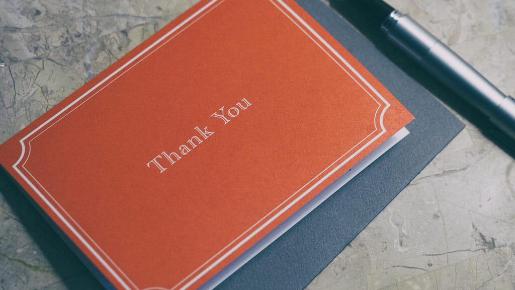 Thank you card with the word thank you written on it